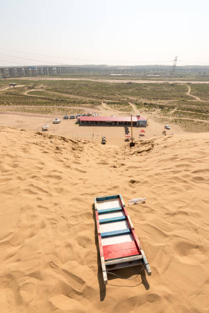 istock Sled used for sand dune sledging in Kubuqi desert in Inner Mongolia, China 1291362094
