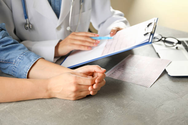 istock Female doctor checking electrocardiogram results with patient 1291363131