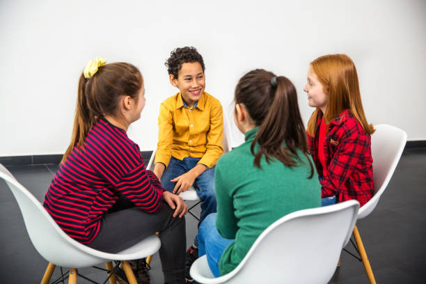 istock Group of children smiling and talking 1291363630