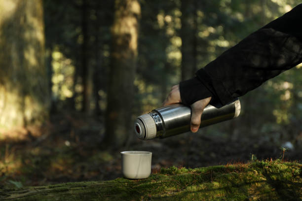 istock A man pours coffee from a thermos into a cup in forest 1291363741