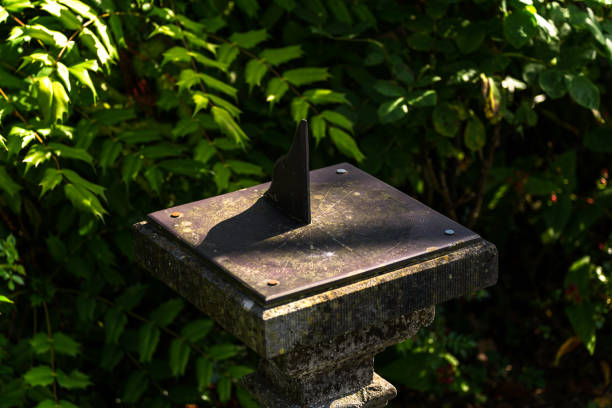 Ancient sundial in the shadows of trees Ancient sundial in the shadows of trees ancient sundial stock pictures, royalty-free photos & images