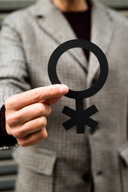 istock person showing a non-binary gender symbol 1291364515