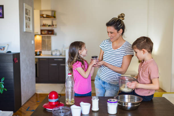 istock Happy family making cake together 1291366029