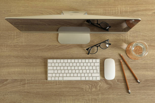istock Concept of workplace with modern desktop computer on wooden background 1291368617