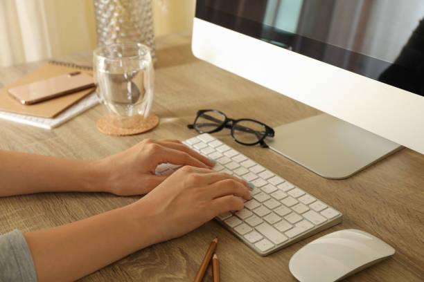 istock Woman working on desktop computer on wooden table 1291368685