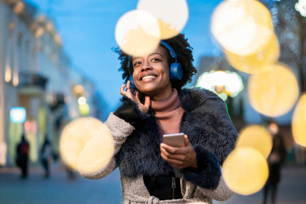 istock Young woman using smart phone at the street 1291369149