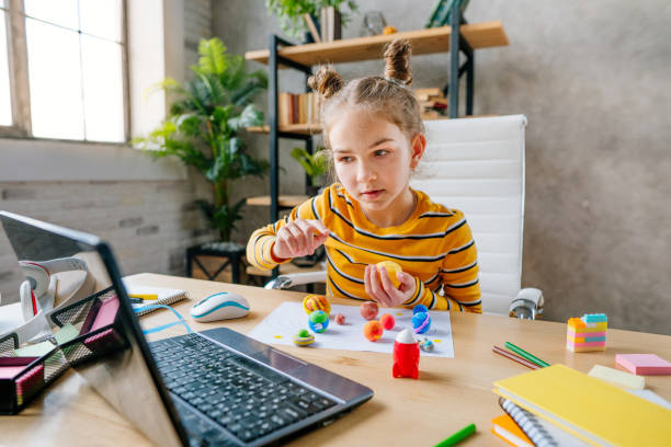 istock Girl using laptop to study online planets of Solar system 1291369263