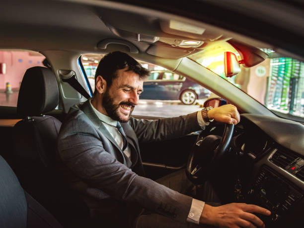 istock Man turning on his car radio while driving 1291370262