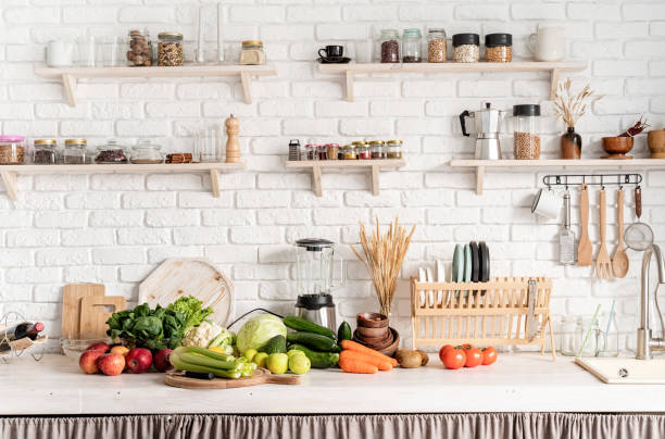 istock Close up of table with green vegetables in the kitchen 1291370492