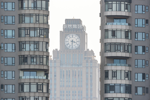 Chengdu, Sichuan province, China - July 2, 2020 : Global Times Center clock tower behind residential buildings