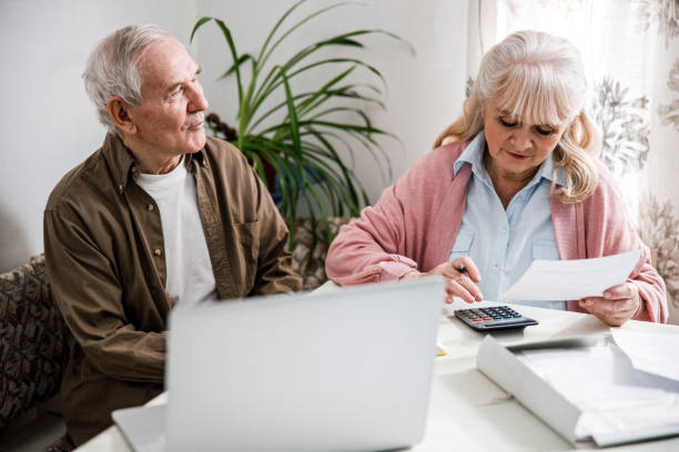 istock Worried senior couple checking bills 1291374291