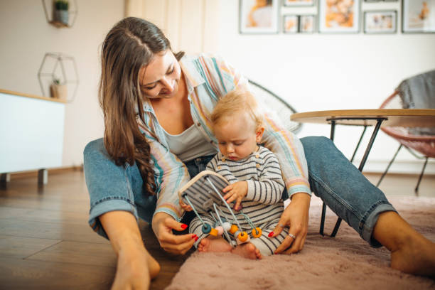 istock Young mom plays with her baby 1291378062