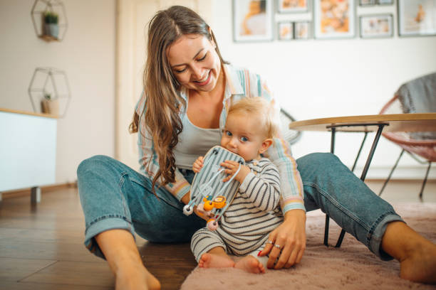 istock Young mom plays with her baby 1291378098