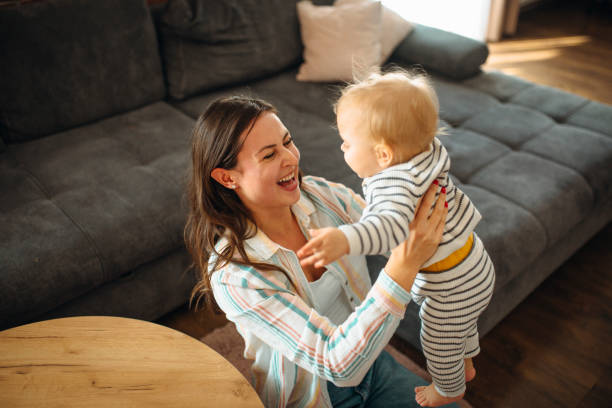 istock Young mom plays with her baby 1291378111