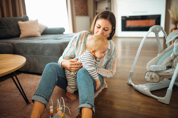 istock Young mom plays with her baby 1291378120