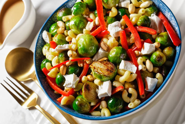 istock macaroni salad with broccoli sprouts, bell pepper strips, feta and peanut 1291380868
