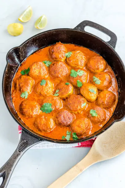 Butter Chicken Meatballs in a Skillet on White Background Flat Lay Top Down Photo, Indian Food Photography