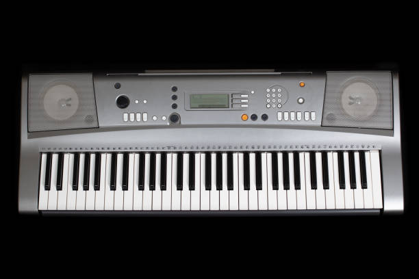 istock grey electronic synthesizer without labels , isolated on a black background 1291382802