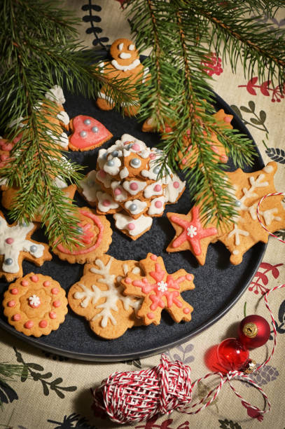 istock Gingerbread Christmas Cookie on Plate and Pine Brunches 1291384733