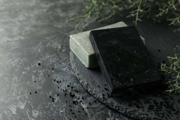 istock Tray with natural handmade soap on black smokey background 1291389480
