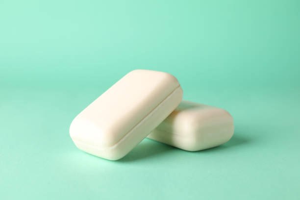 istock Pieces of natural handmade soap on mint background 1291389557