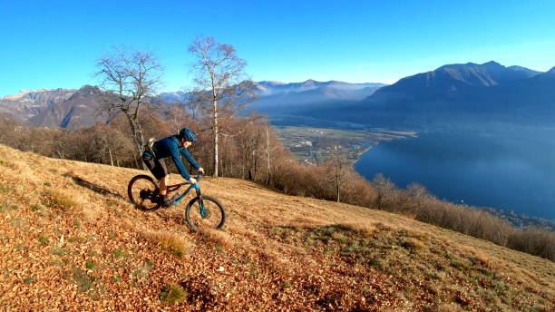 istock Young man mountain bikes down mountain slope in the morning 1291390920