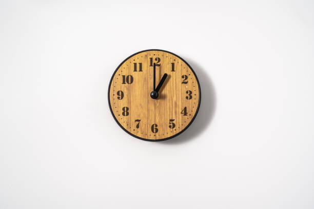 istock wood office wall clock with white dial on white background. wall clock on white background, top view. 1291392585