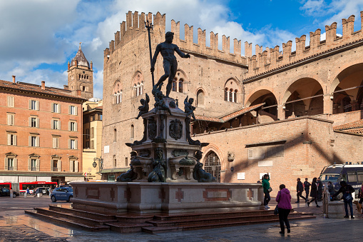 Bologna, Italy - April 05 2019: The Fountain of Neptune (Italian: Fontana di Nettuno) is a monumental civic fountain located in the eponymous square, Piazza del Nettuno, next to Piazza Maggiore.