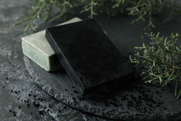 istock Tray with natural handmade soap on black smokey background 1291392973