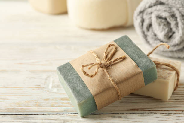 istock Towel and natural soap on wooden background 1291393573