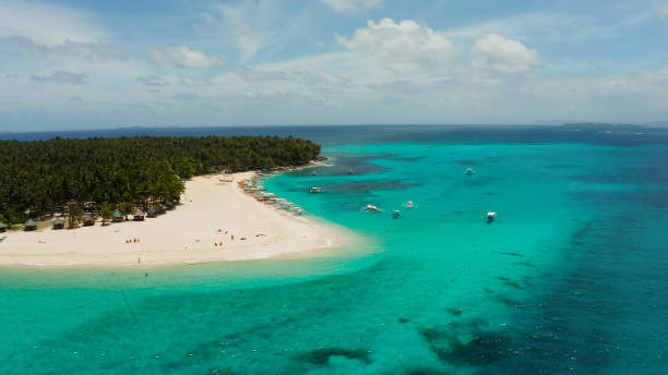 istock Tropical Daco Island with a sandy beach and tourists 1291394502