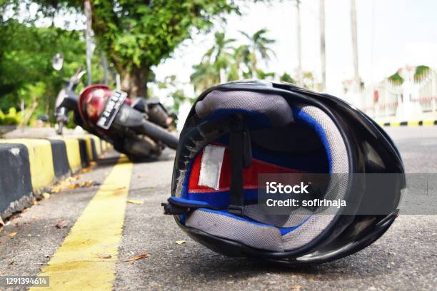 Helmet Fallen On The Street Road Accidents Stock Photo - Download Image Now - Motorcycle, Misfortune, Crash