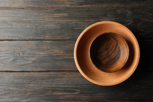 istock Empty wooden bowls on wooden table, top view 1291394796