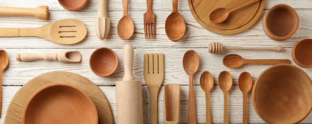 istock Pattern of wooden dishes on white wooden table 1291395421