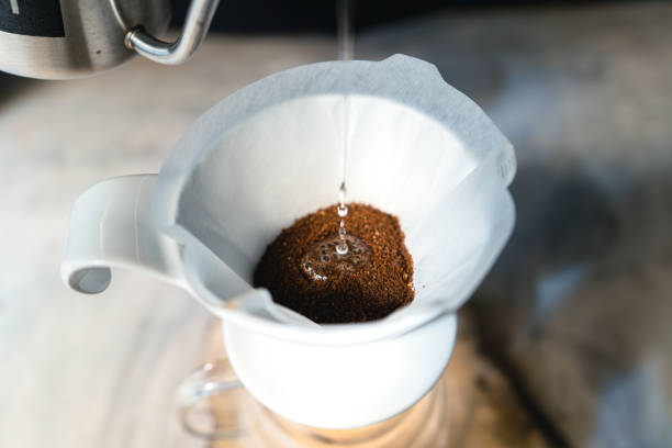 istock Drip coffee, barista pouring water on coffee ground with filter,brewing coffee 1291401042