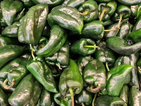 pile of poblano peppers in a market, background and texture