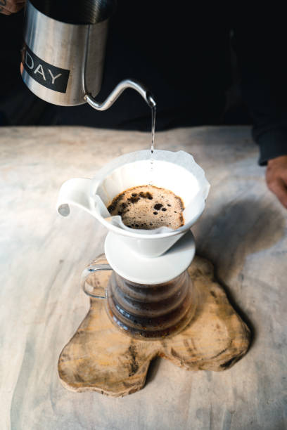 istock Drip coffee, barista pouring water on coffee ground with filter,brewing coffee 1291402293