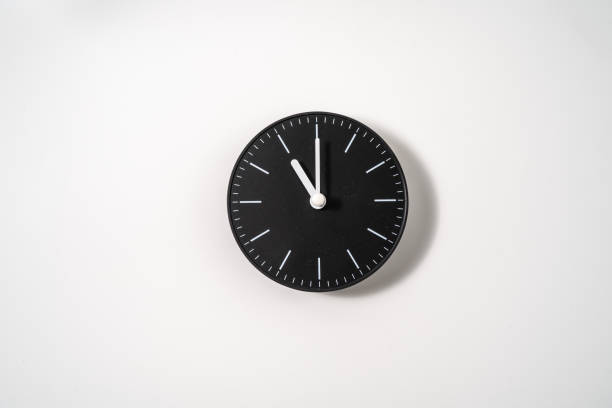 istock close up of an office clock on white background with clipping path 1291402396