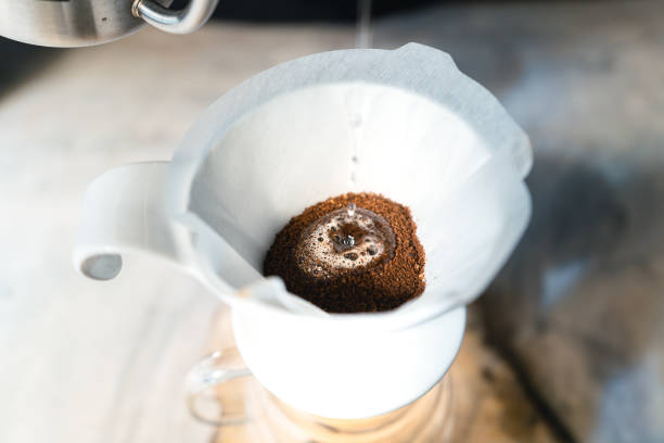 istock Drip coffee, barista pouring water on coffee ground with filter,brewing coffee 1291402438