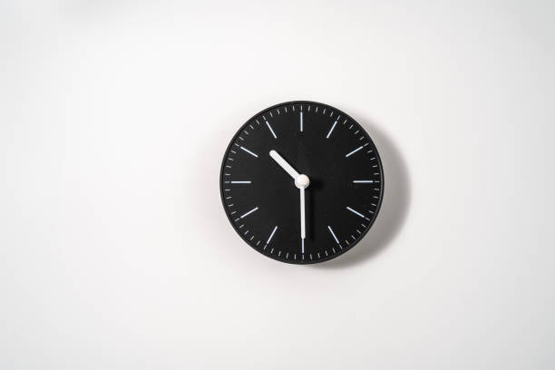 istock close up of an office clock on white background with clipping path 1291402465
