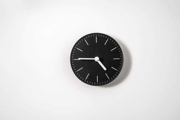 istock close up of an office clock on white background with clipping path 1291403230