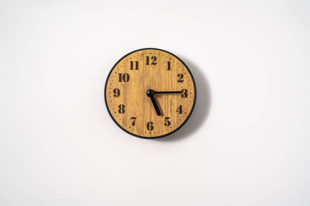 istock wood office wall clock with white dial on white background. wall clock on white background, top view. 1291403442