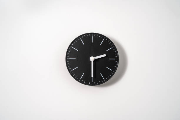 istock close up of an office clock on white background with clipping path 1291403622