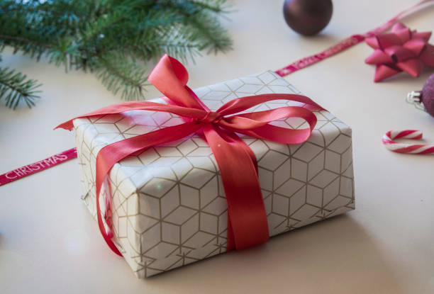 istock Christmas gift box with red ribbon 1291403768