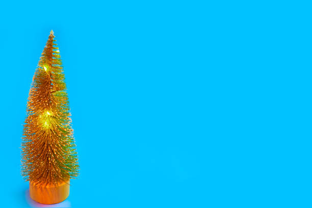 istock Christmas tree on blue background, abstract background, minimalistic new year concept. 1291405241