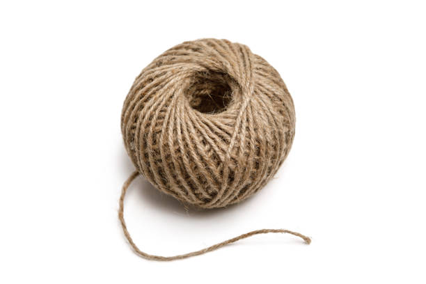 Whole ball of natural colored jute twine for arts and crafts projects isolated on a white background