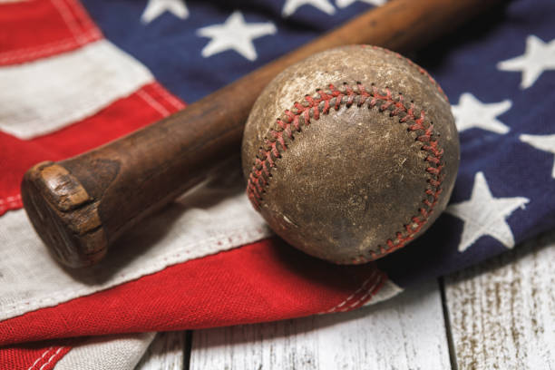 istock Vintage Baseball and Bat on an American Flag 1291408663