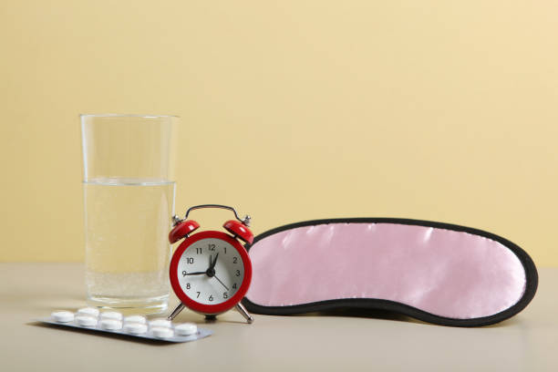 istock Composition on the theme of insomnia on a colored background 1291409561