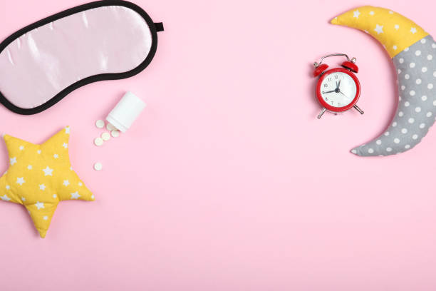 istock Composition on the theme of insomnia on a colored background 1291410256