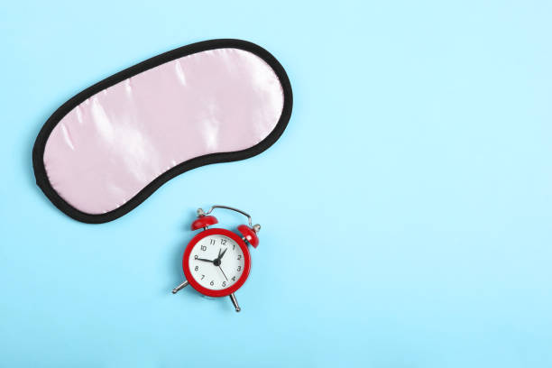 istock Composition on the theme of insomnia on a colored background 1291410421